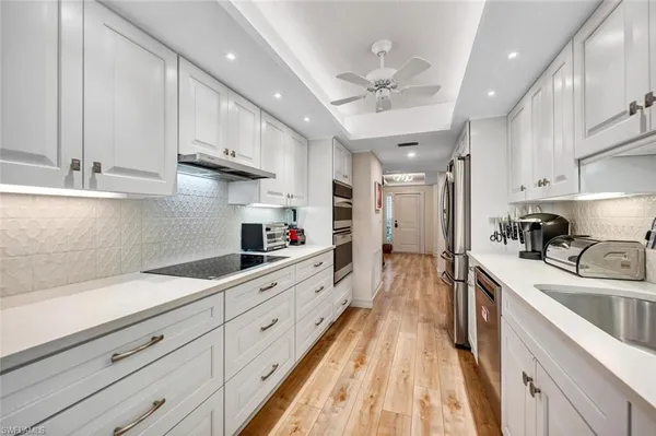 a kitchen with cabinets a sink and appliances