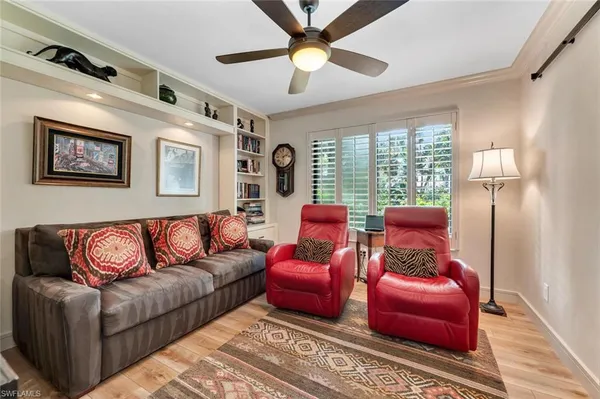 a living room with furniture a ceiling fan and a rug
