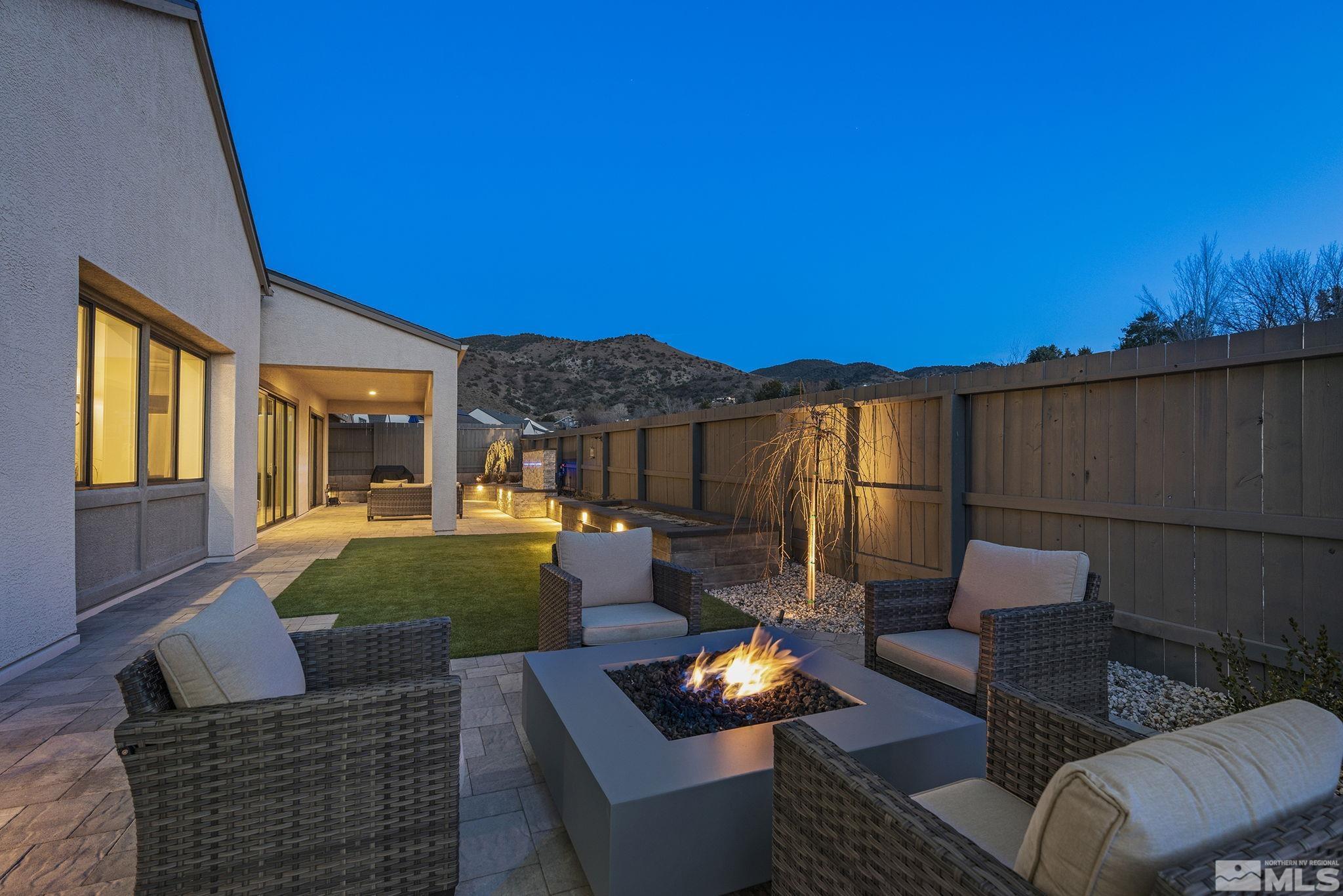 3012 Feathertop Drive Reno, NV 89521 - Photo 14 of 40 a view of a patio with couches chairs potted plants and wooden floor