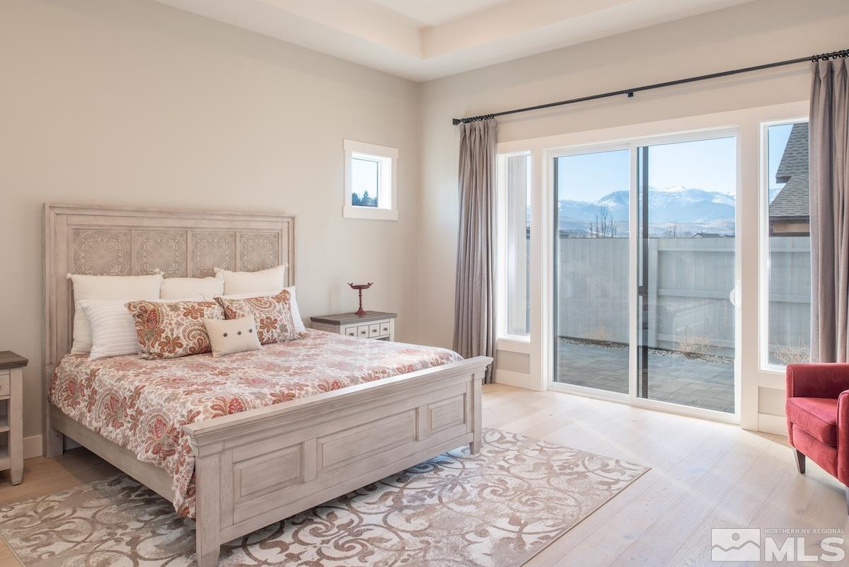 3012 Feathertop Drive Reno, NV 89521 - Photo 23 of 40 a bedroom with a large bed and a glass door