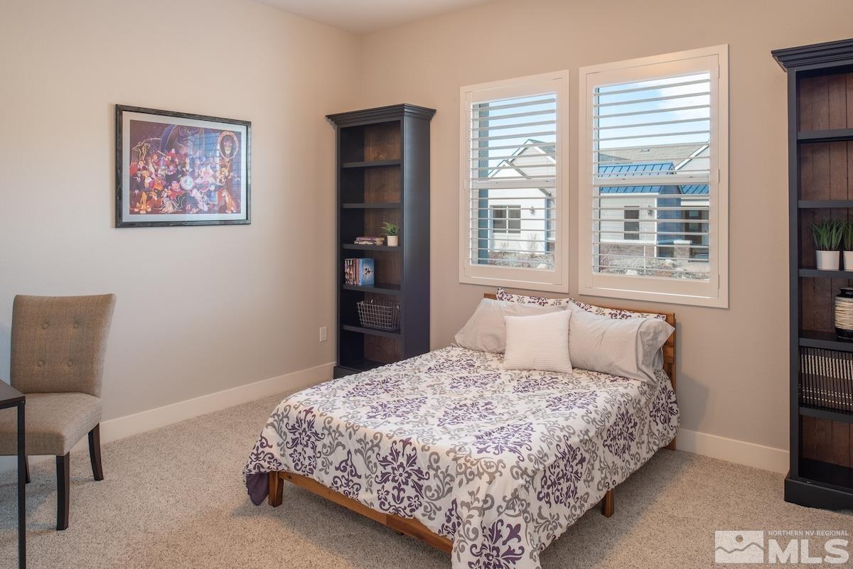 3012 Feathertop Drive Reno, NV 89521 - Photo 27 of 40 a bedroom with a bed painting on wall and a large window