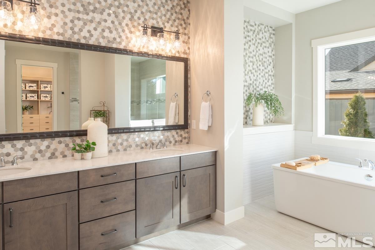 3012 Feathertop Drive Reno, NV 89521 - Photo 3 of 40 a bathroom with a sink mirror and a bathtub