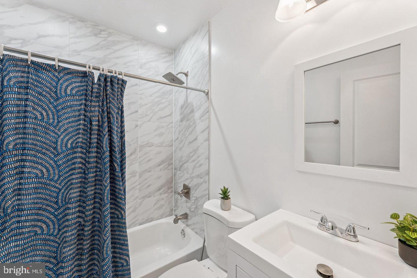718 Jackson Street Northeast, Unit 1 Washington, DC 20017 - Photo 11 of 22 a bathroom with a sink and a bathtub