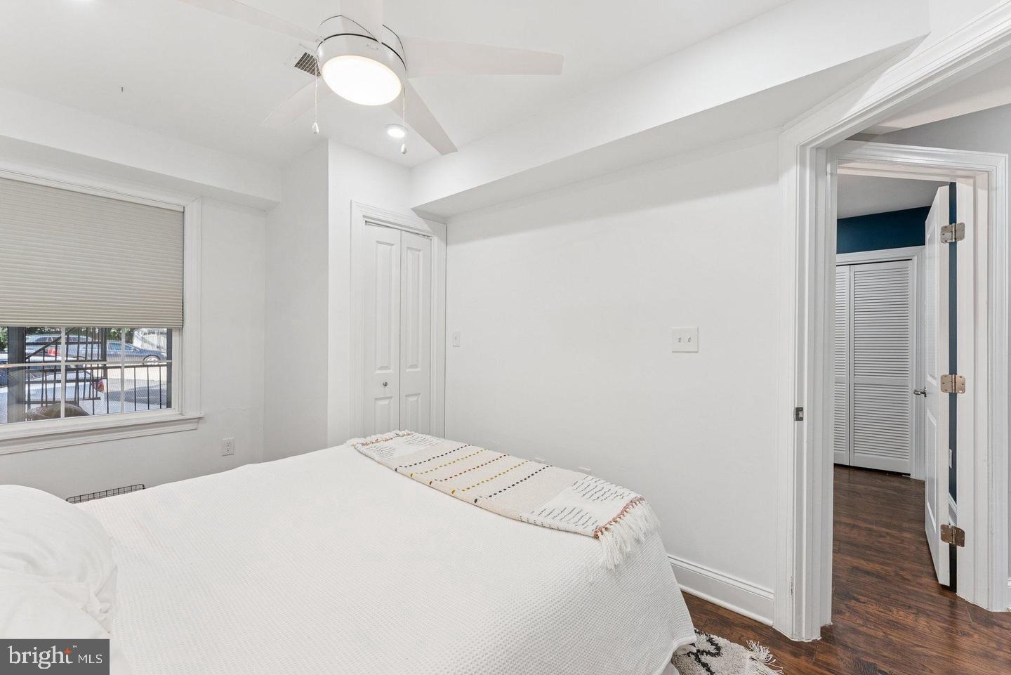 718 Jackson Street Northeast, Unit 1 Washington, DC 20017 - Photo 13 of 22 a bedroom with a bed and a window