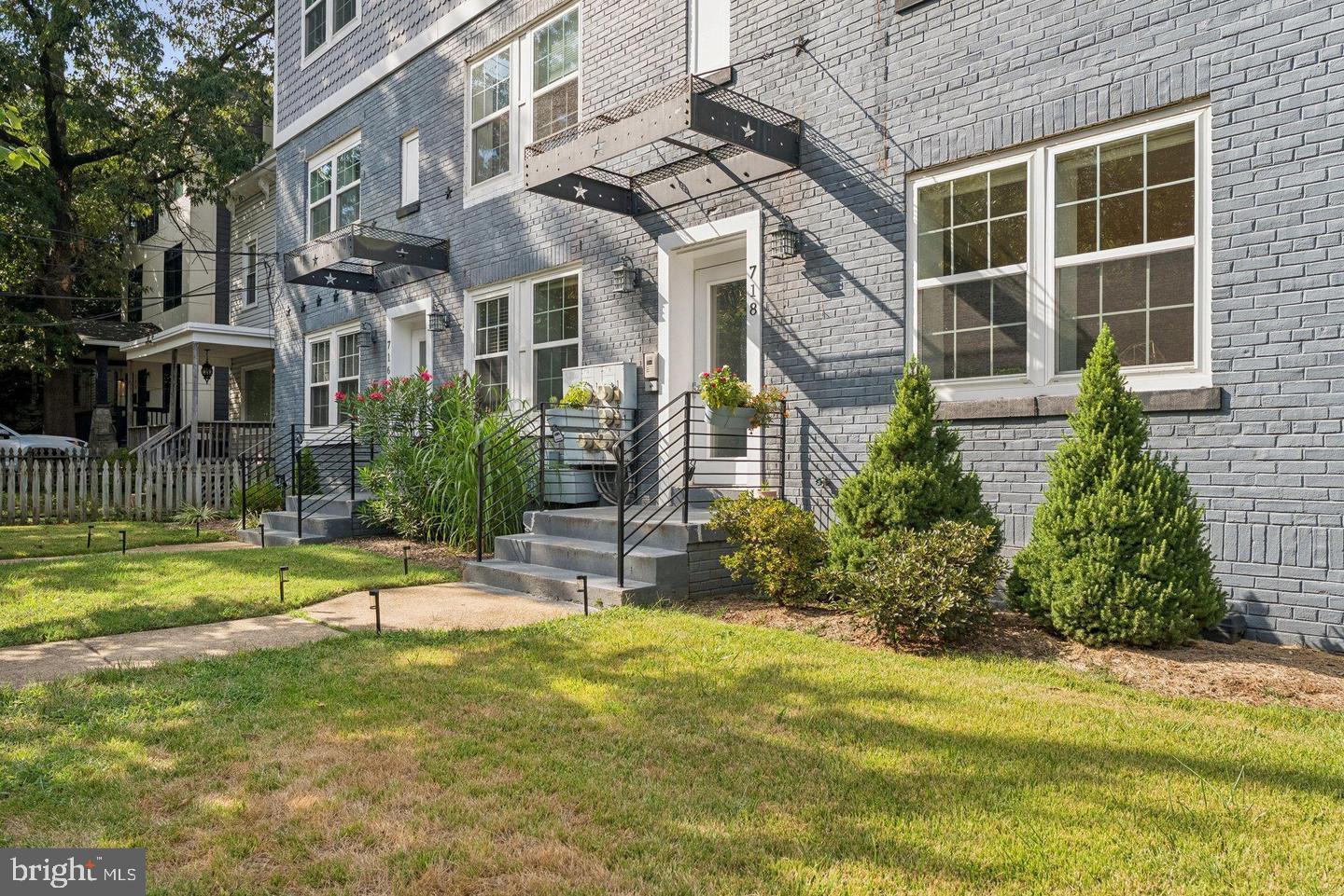 718 Jackson Street Northeast, Unit 1 Washington, DC 20017 - Photo 22 of 22 a view of a house with a yard and sitting area
