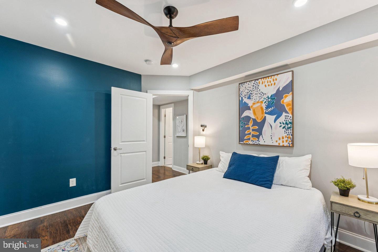 718 Jackson Street Northeast, Unit 1 Washington, DC 20017 - Photo 9 of 22 a bedroom with a bed and a painting on the wall