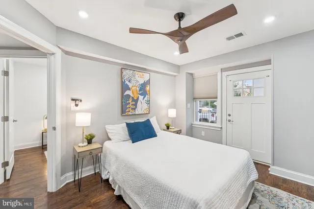 a bedroom with a large bed and a chandelier