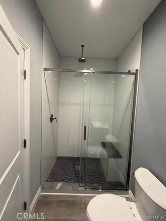 a bathroom with a toilet and a shower