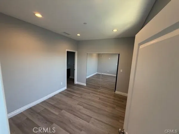 a view of hallway with wooden floor