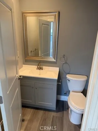 a bathroom with a sink mirror vanity and toilet