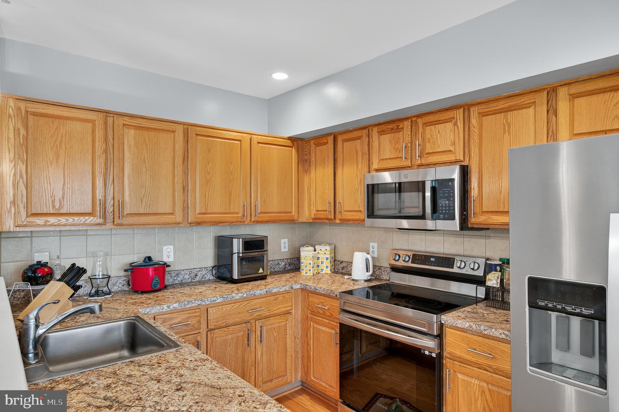 2046 University Boulevard West, Unit 12 Silver Spring, MD 20902 - Photo 12 of 64 a kitchen with stainless steel appliances granite countertop a sink dishwasher refrigerator and a stove top oven