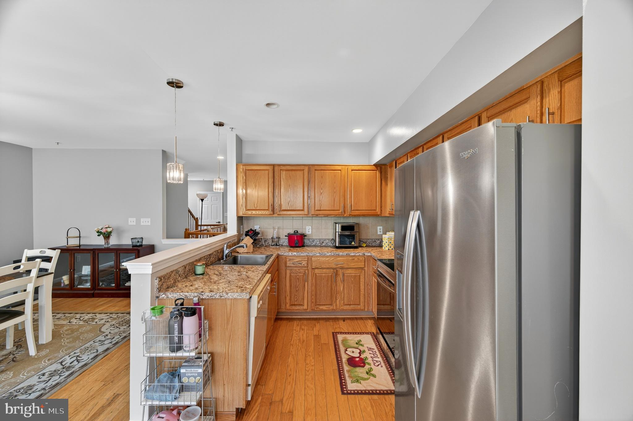 2046 University Boulevard West, Unit 12 Silver Spring, MD 20902 - Photo 13 of 64 a kitchen with stainless steel appliances granite countertop a refrigerator a stove and a sink