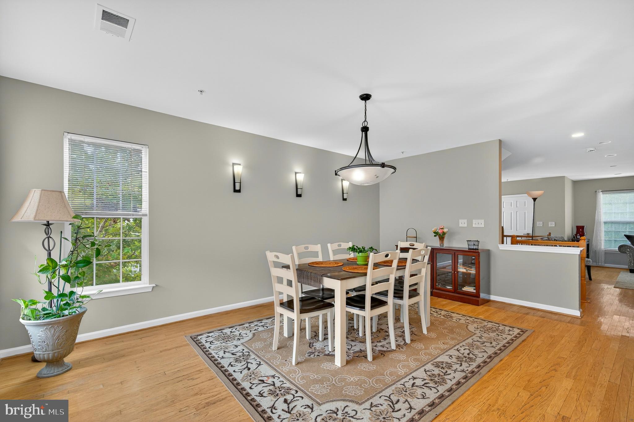 2046 University Boulevard West, Unit 12 Silver Spring, MD 20902 - Photo 16 of 64 a view of a dining room with furniture window and wooden floor