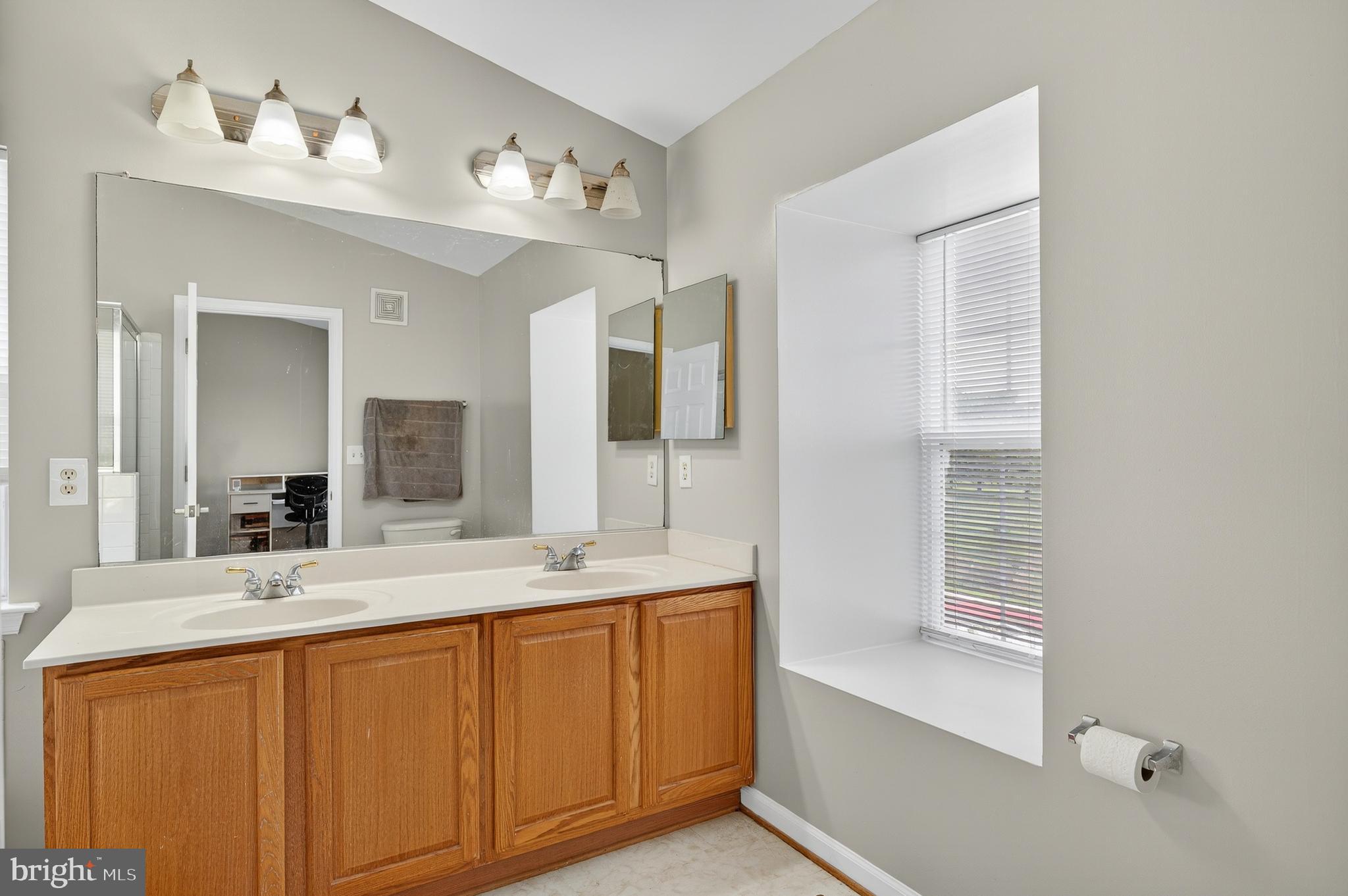 2046 University Boulevard West, Unit 12 Silver Spring, MD 20902 - Photo 27 of 64 a bathroom with a granite countertop sink mirror and double
