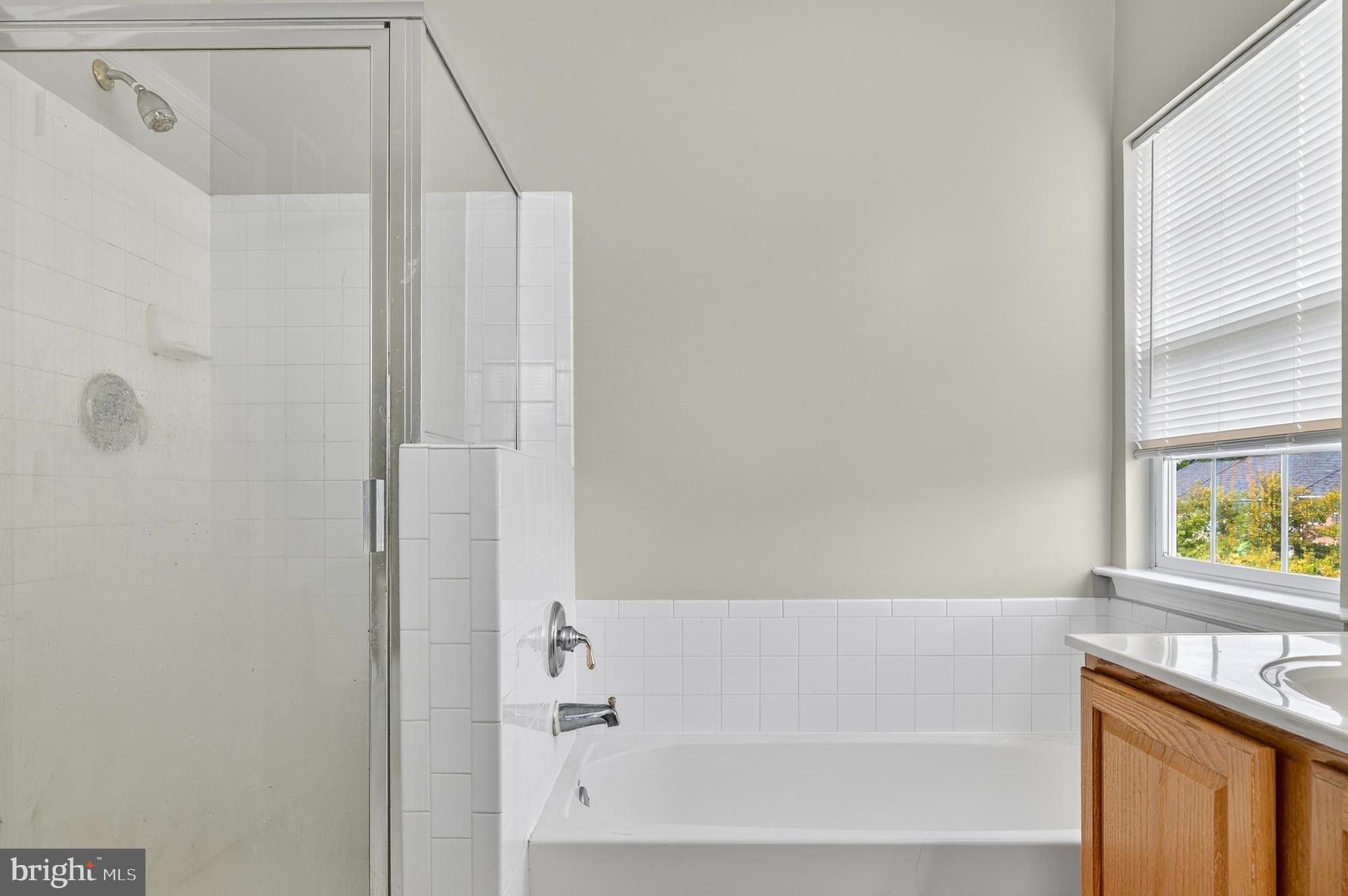 2046 University Boulevard West, Unit 12 Silver Spring, MD 20902 - Photo 28 of 64 a bathroom with a bathtub and a window