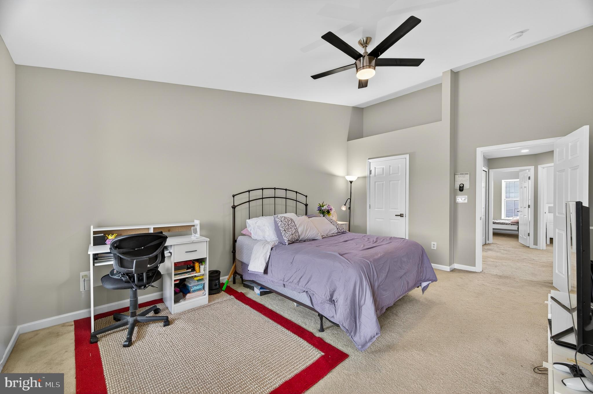 2046 University Boulevard West, Unit 12 Silver Spring, MD 20902 - Photo 29 of 64 a bedroom with a bed a desk and chair