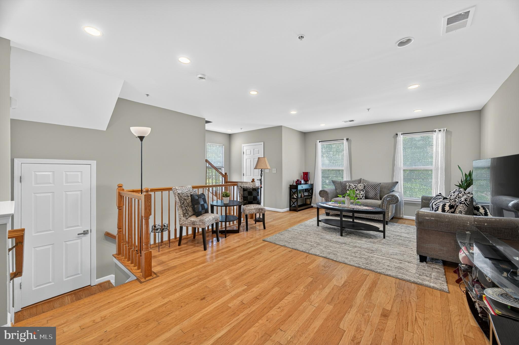2046 University Boulevard West, Unit 12 Silver Spring, MD 20902 - Photo 9 of 64 a living room with furniture a wooden floor and a window