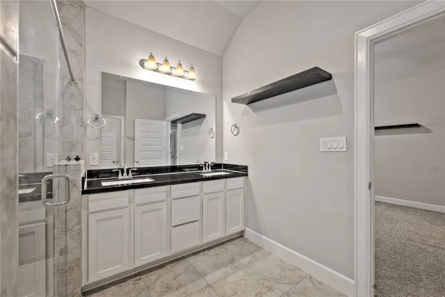 a kitchen with granite countertop a sink and a refrigerator