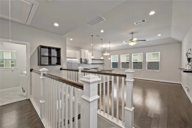 a view of a kitchen with wooden floor and a window