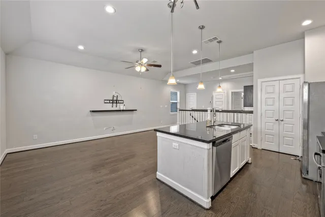 a kitchen with stainless steel appliances granite countertop a stove and a large kitchen counter space