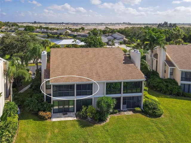 an aerial view of a house with swimming pool and outdoor seating