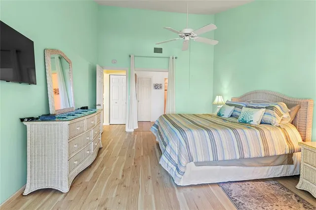 a bedroom with a bed a lamp and a chandelier