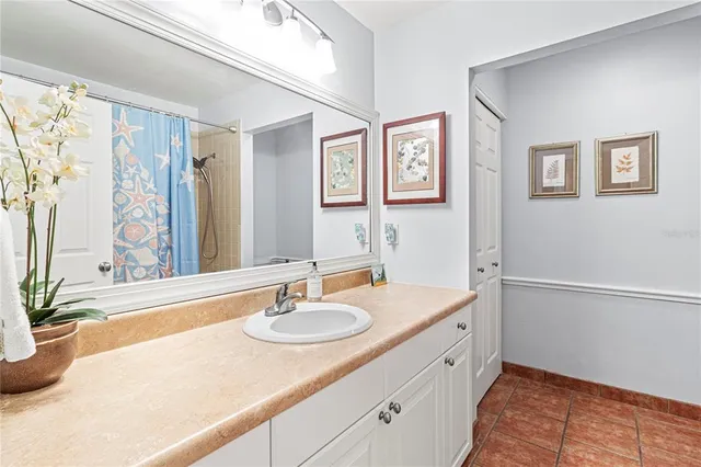 an aerial view of a house with a yard lake view and large trees