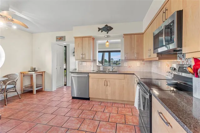 an aerial view of a house with a garden and lake view
