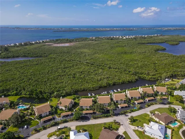 an aerial view of a house with swimming pool and outdoor seating