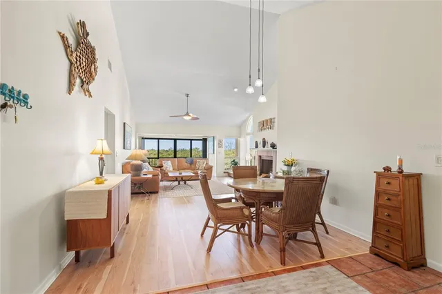 a dining room with furniture a rug and wooden floor
