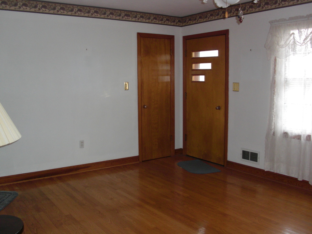 12083 Hardy Road Hardy, VA 24101 - Photo 2 of 19 a view of an empty room with wooden floor and a window