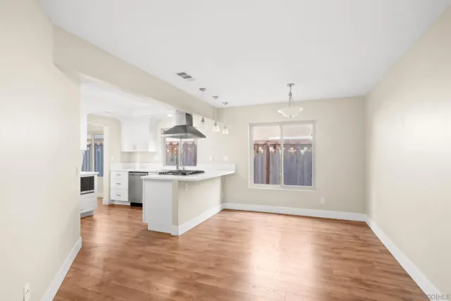 a view of an entryway with wooden floor