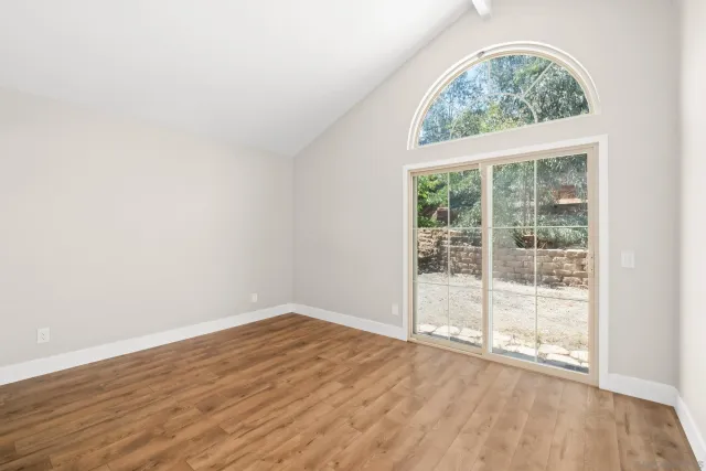 an empty room with wooden floor