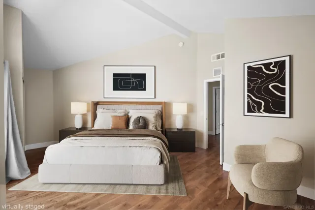 an empty room with wooden floor and entrance