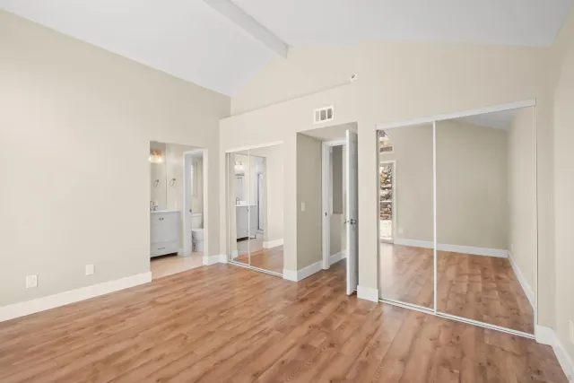 a bathroom with a sink mirror vanity and toilet
