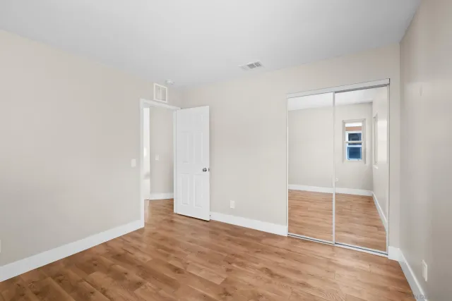 a view of a kitchen cabinets and wooden floor