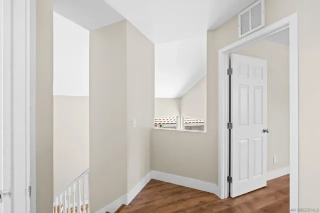 a vase of flowers sitting on a wooden floor