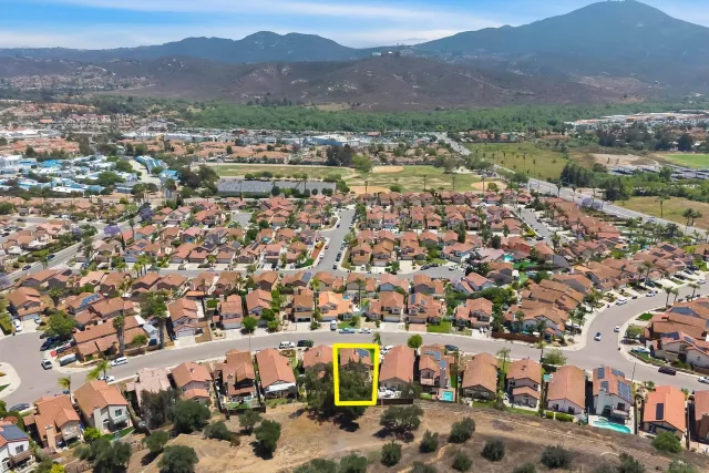 an aerial view of residential building with green space