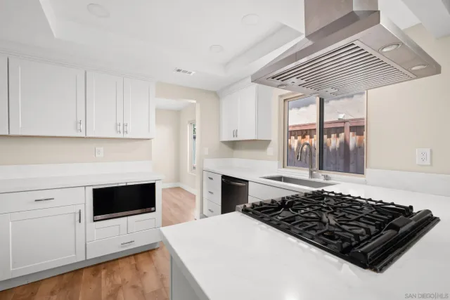 a kitchen with stainless steel appliances a sink and a stove
