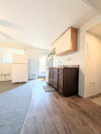 a view of a kitchen with wooden floor