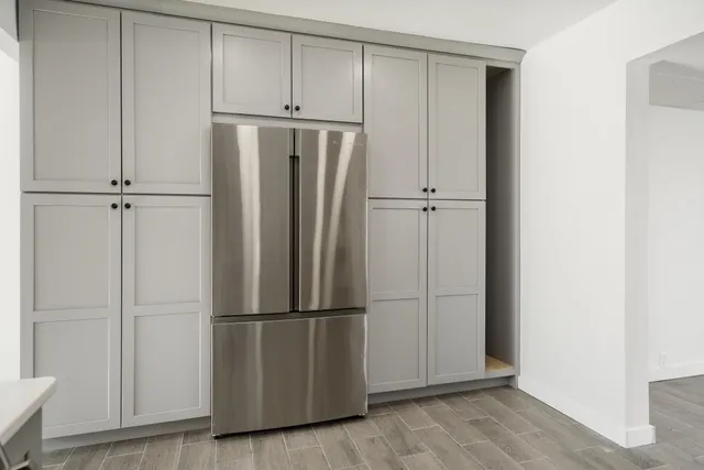 a view of empty room with wooden floor