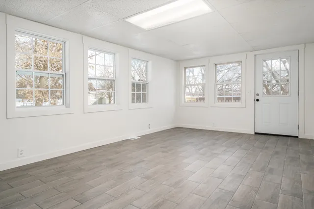 wooden floor in an empty room with a window