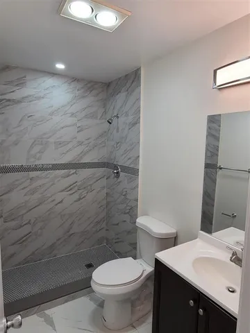 a bathroom with a toilet and a shower