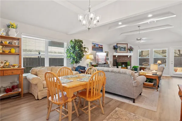 a living room with furniture a fireplace and a large window
