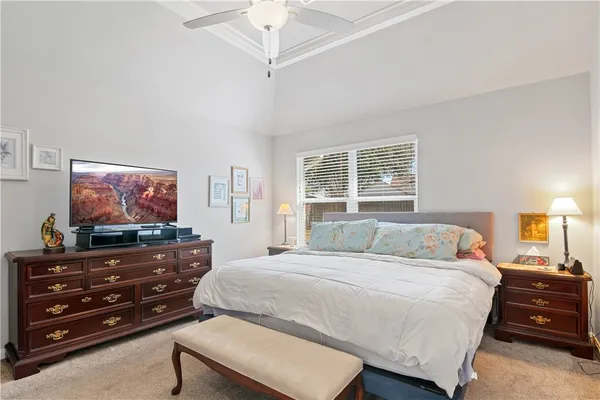 a bedroom with a bed and flat screen tv