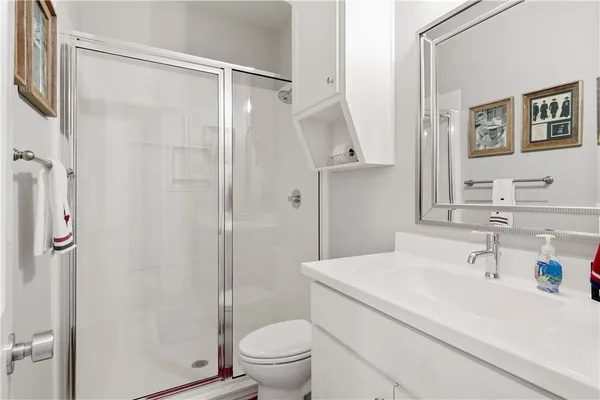 a bathroom with a sink toilet and shower