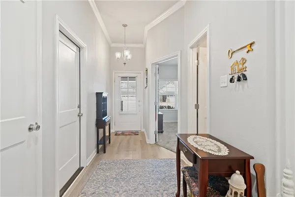a view of a hallway with bathroom and shower