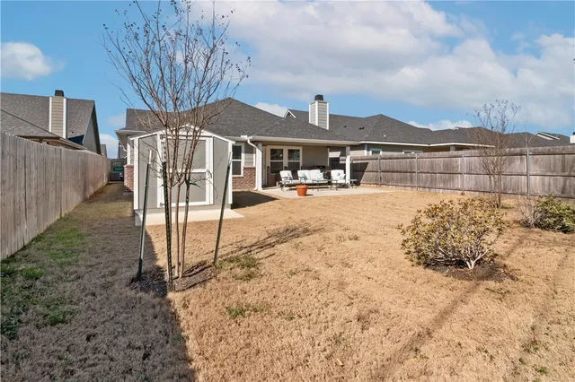 a view of a house with wooden fence