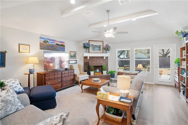 a living room with furniture a fireplace and a chandelier