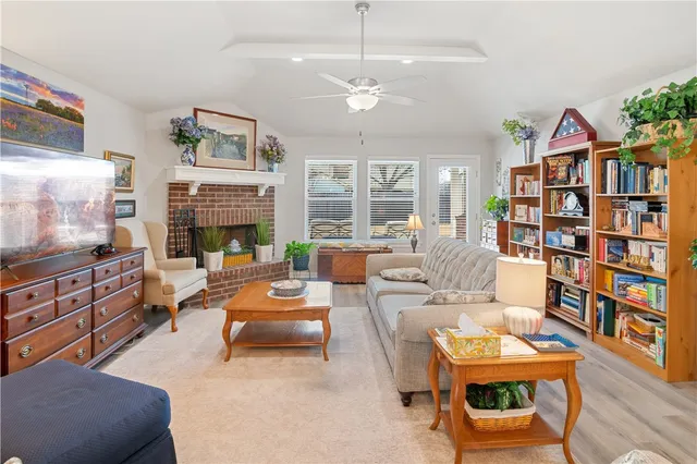 a living room with fireplace furniture and a flat screen tv